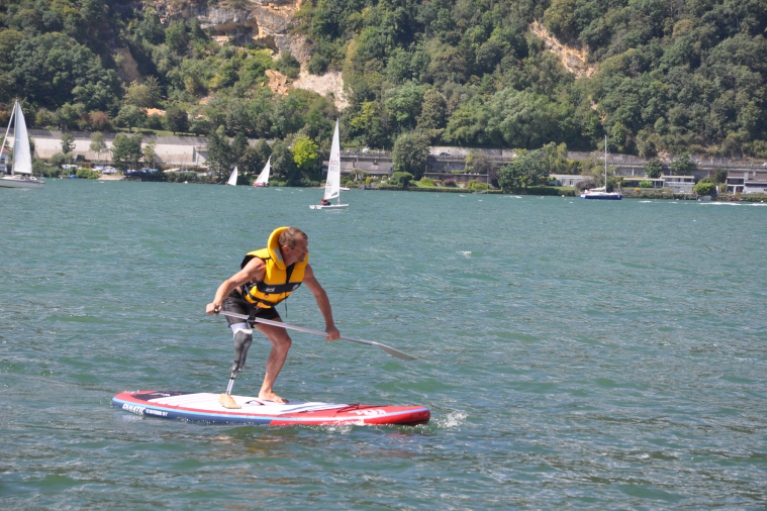 Athlete with lower leg amputation on stand-up paddle board