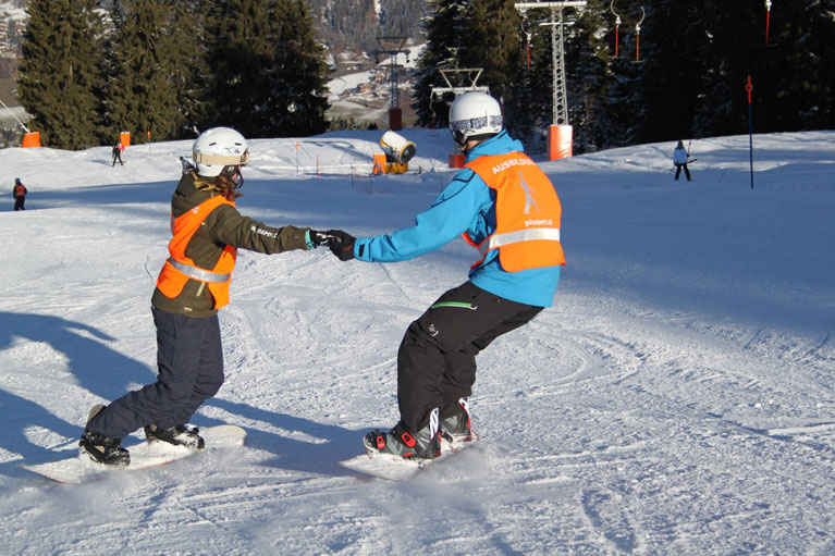 Deux snowboardeurs s’exercent à la descente 